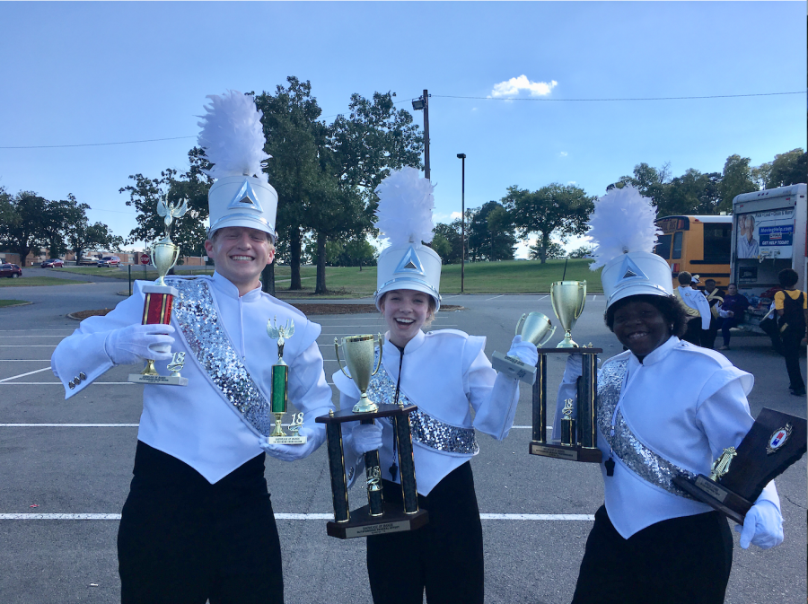 Drum Majors Chris Walters (left), Riley Parker (middle) and Journee Jones (right)show off Conway’s numerous trophies earned at War Memorial.