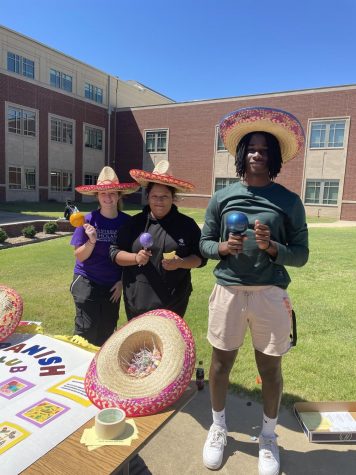 Hailey Bearden, Cinthia Solis, and Marquavis Stuckett represent the Spanish Club at the club fair in the courtyard during both lunches on September 9.  Over 20 clubs set up displays to recruit members.  “I really enjoy being in Spanish Club because I get to expand my knowledge of other cultures, Stuckett said. .