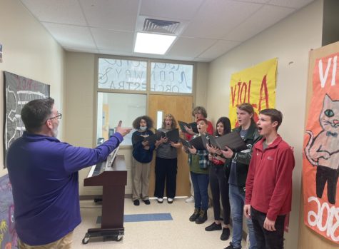 Choir Director Sam Huskey teaches students songs for the musical.
