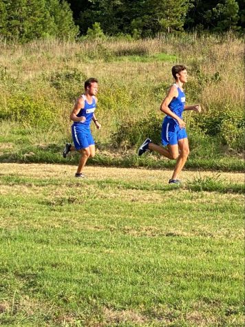 Junior Max Henry and Senior Charlie Meek run their first race of the season at the Mustang Invitational in Perryville Tuesday.  