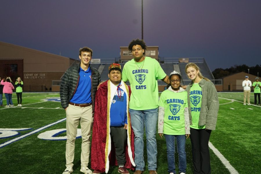 Members of Caring Cats pose with Powder Puff Royalty King Elkin Suastegui and Queen Kalia Tolliver.  