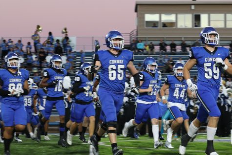 Senior Aaron Smith (#65) leads the Wampus Cats onto the field against North Little Rock.  Smith is having a big season and is gaining attention from colleges.  