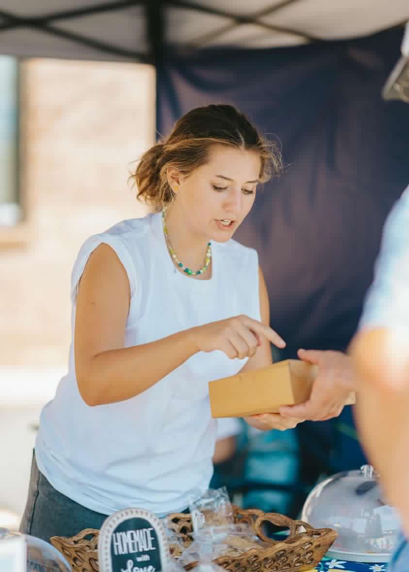 Senior Sarah Carter sells her baked goods at the local Farmers Market. 