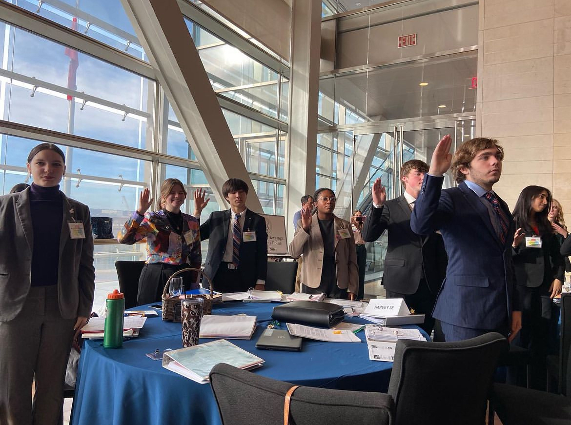 Students on the debate team take the oath of office at Arkansas Student Congress