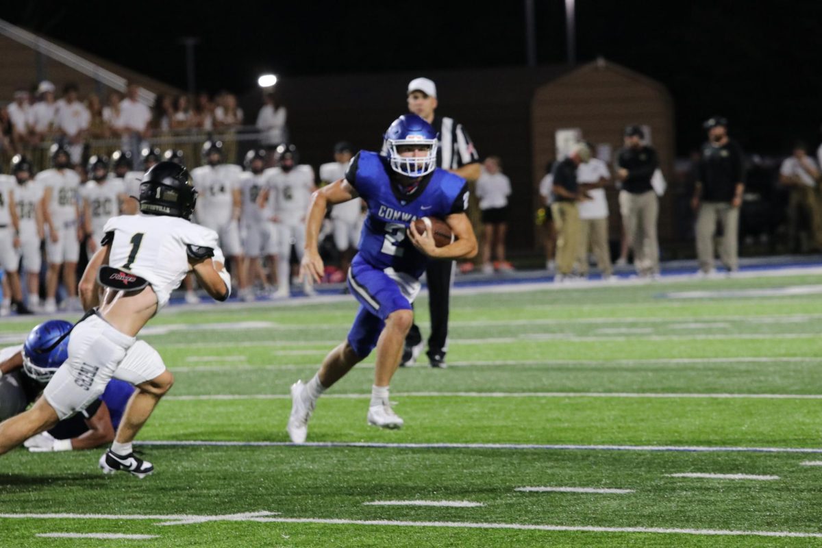 Senior QB Grayson Wilson runs the ball against Bentonville in the Cats Home Opener. 