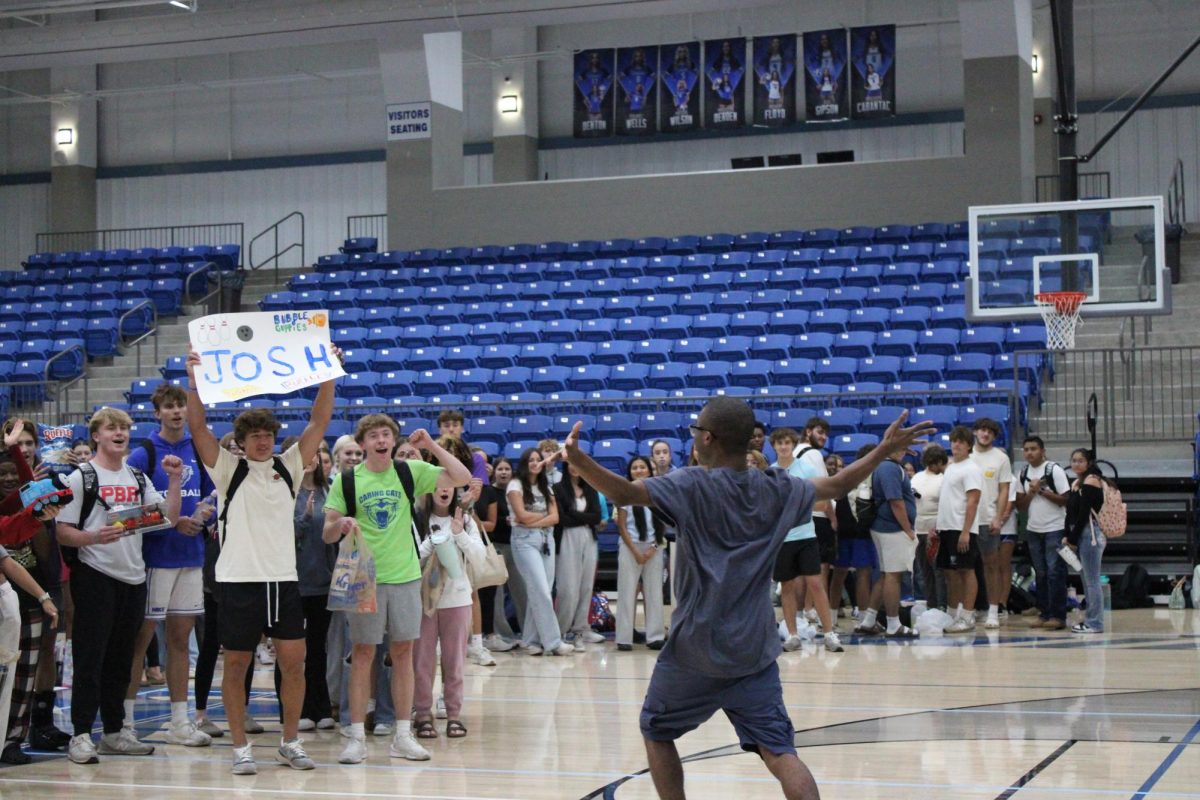 A Caring Cats family including juniors Carter Crow and Hutson Teague greet their Buddy Josh Woods at the Buddy Reveal September 15. 