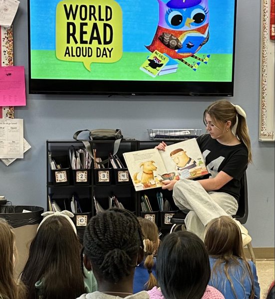 Senior Gracelle French reads to an elementary class as part of her introduction to education course.  In addition to classes, French uses cheer and babysitting to prepare for her future career. 