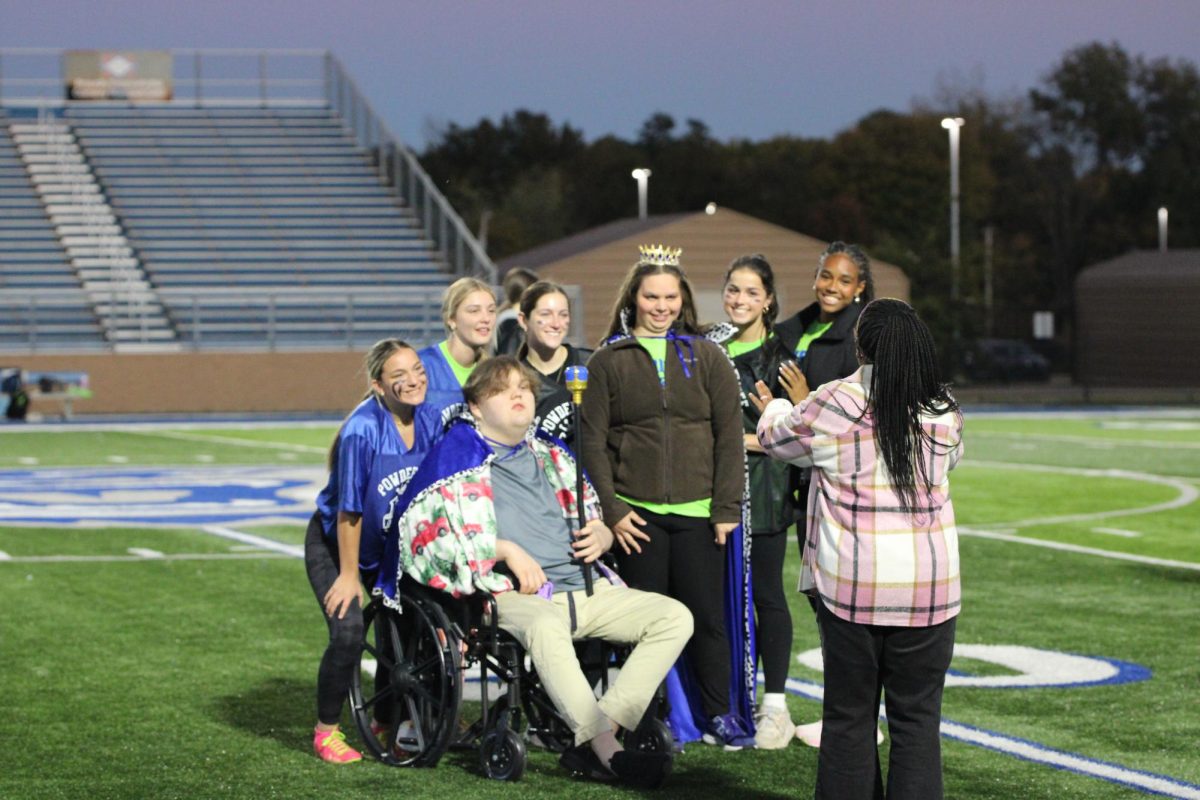 Caring Cats Sponsor Denisha Knapp takes a picture of Powderpuff King and Queen, Ayden Judd and Shelby Dillard. 