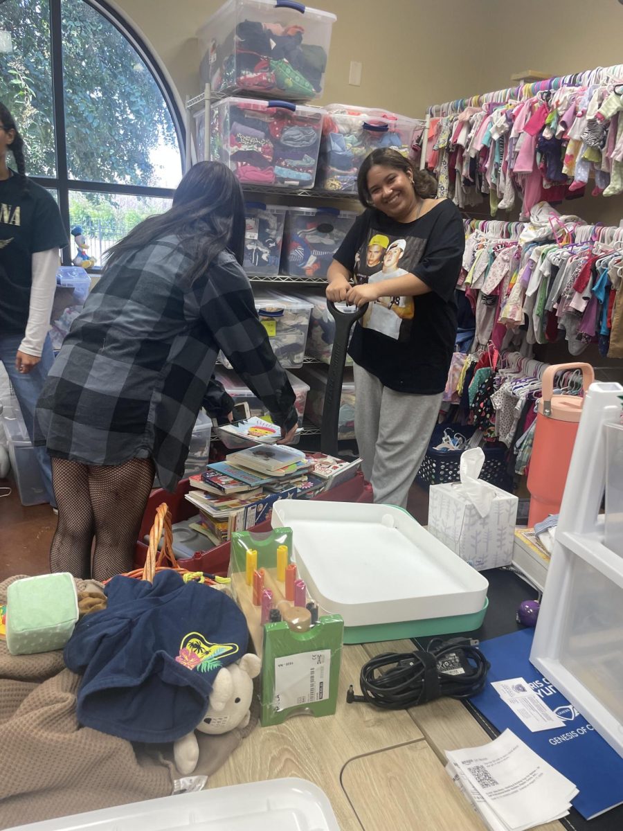 Seniors Janaya Harris and Marley Crawford are packing up books to take to children at Cradle Care. 