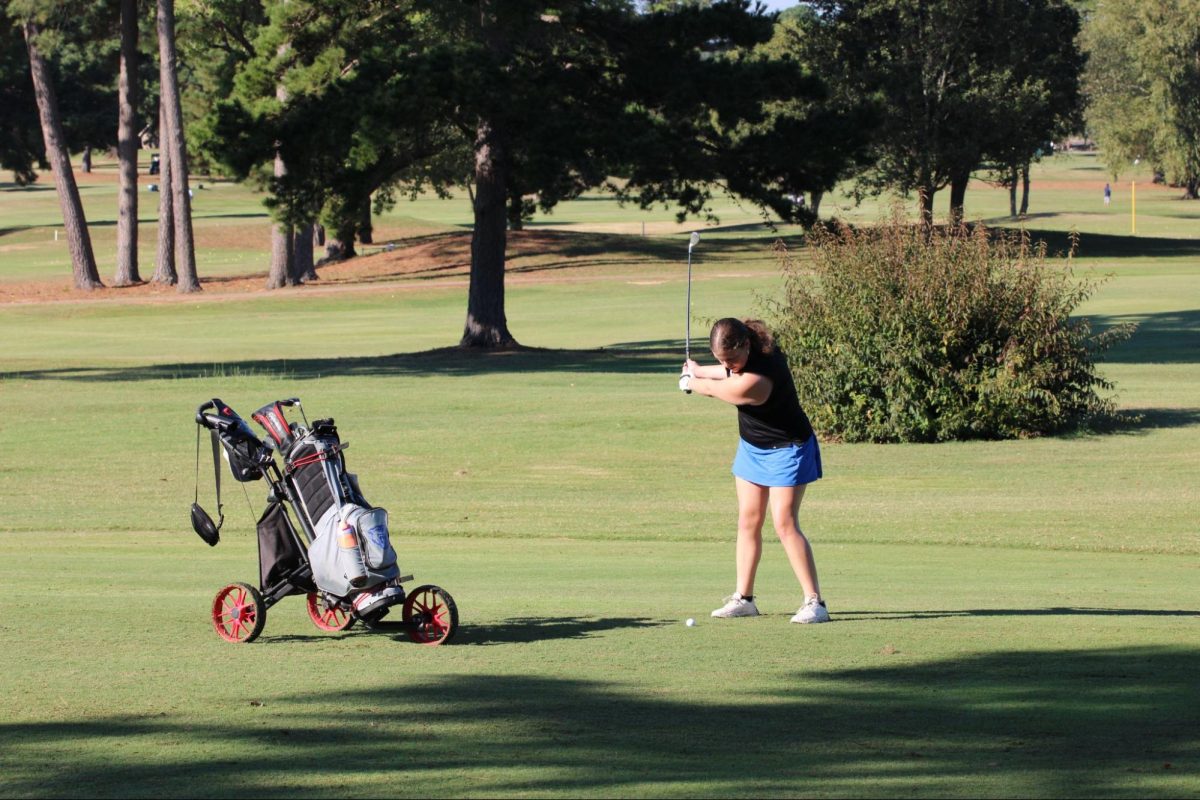 Senior Abbey Schrick tees up for her swing at the State Tournament.