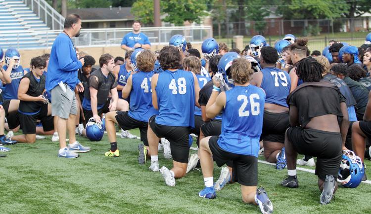 Head Coach Buck James speaks to his team after practice. 