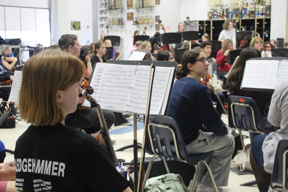 Orchestra students practice their music during class. 