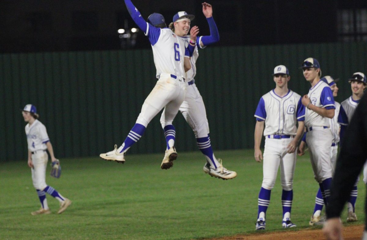Senior Jackson Robnett and another teammate jump up to celebrate against Russellville where they won 4-0