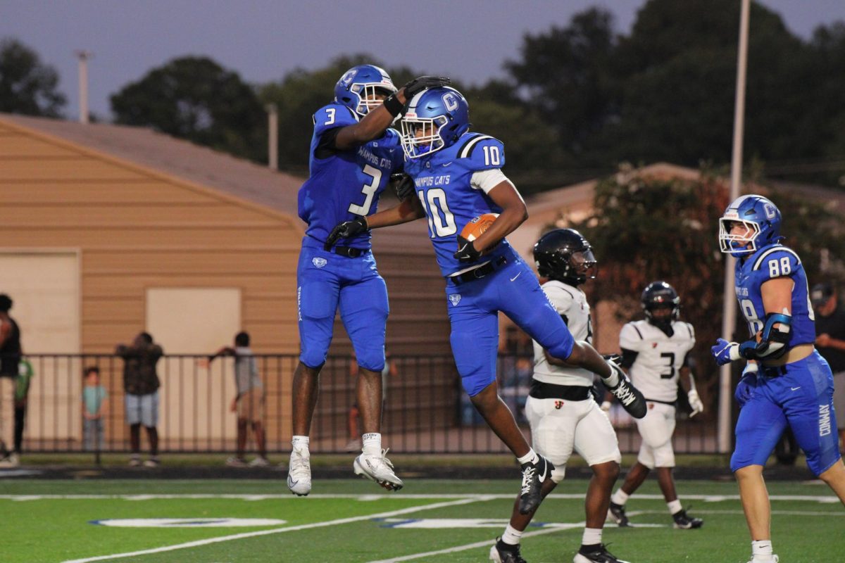 Alex McCray,12 and Kambrien Blackmon, 11 celebrate after a play in the first football game. 