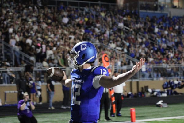 Senior Wesley Tapp holding the football after a play. 