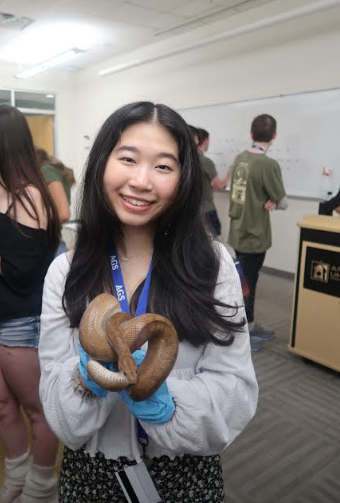 Angel Tran holding a snake during the evolution class. Each class lasted a week and focused on different aspects of science. 
