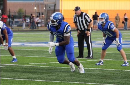 Senior Joseph Washington makes a defensive play during a football game. 