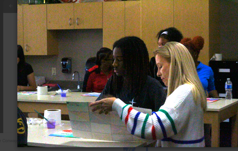 Sean Williams discusses his latest project with his art teacher. 