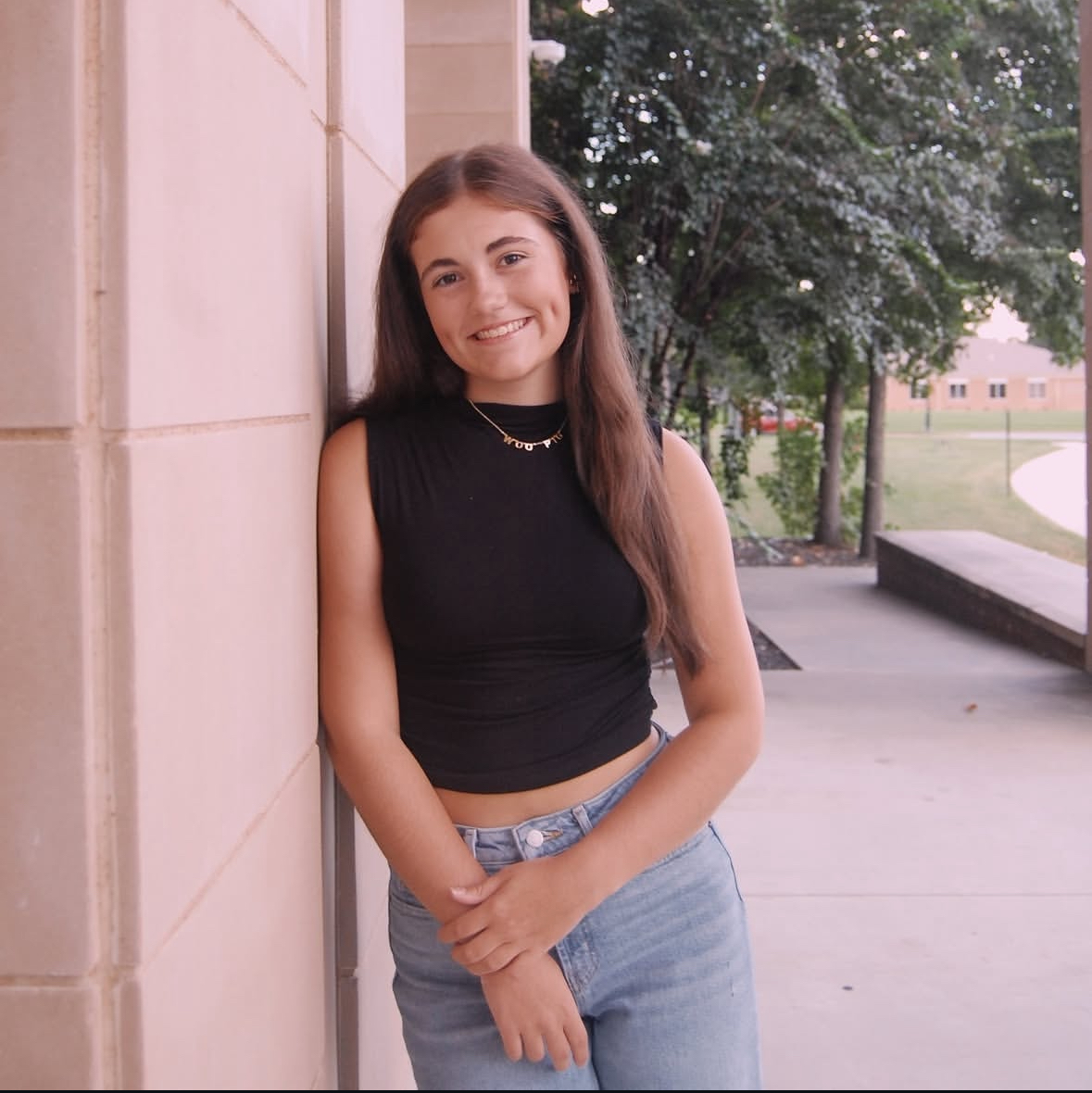 Carly Schluterman posing outside of the high school.