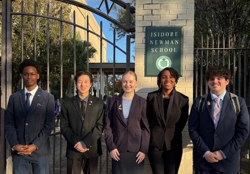 Members of Speech and Debate pose outside the gates of Isidore Newman during their tournament in December.