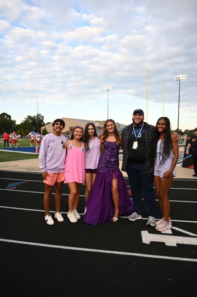 Mr. A poses with producers of Six Leg Media during the Homecoming football game.